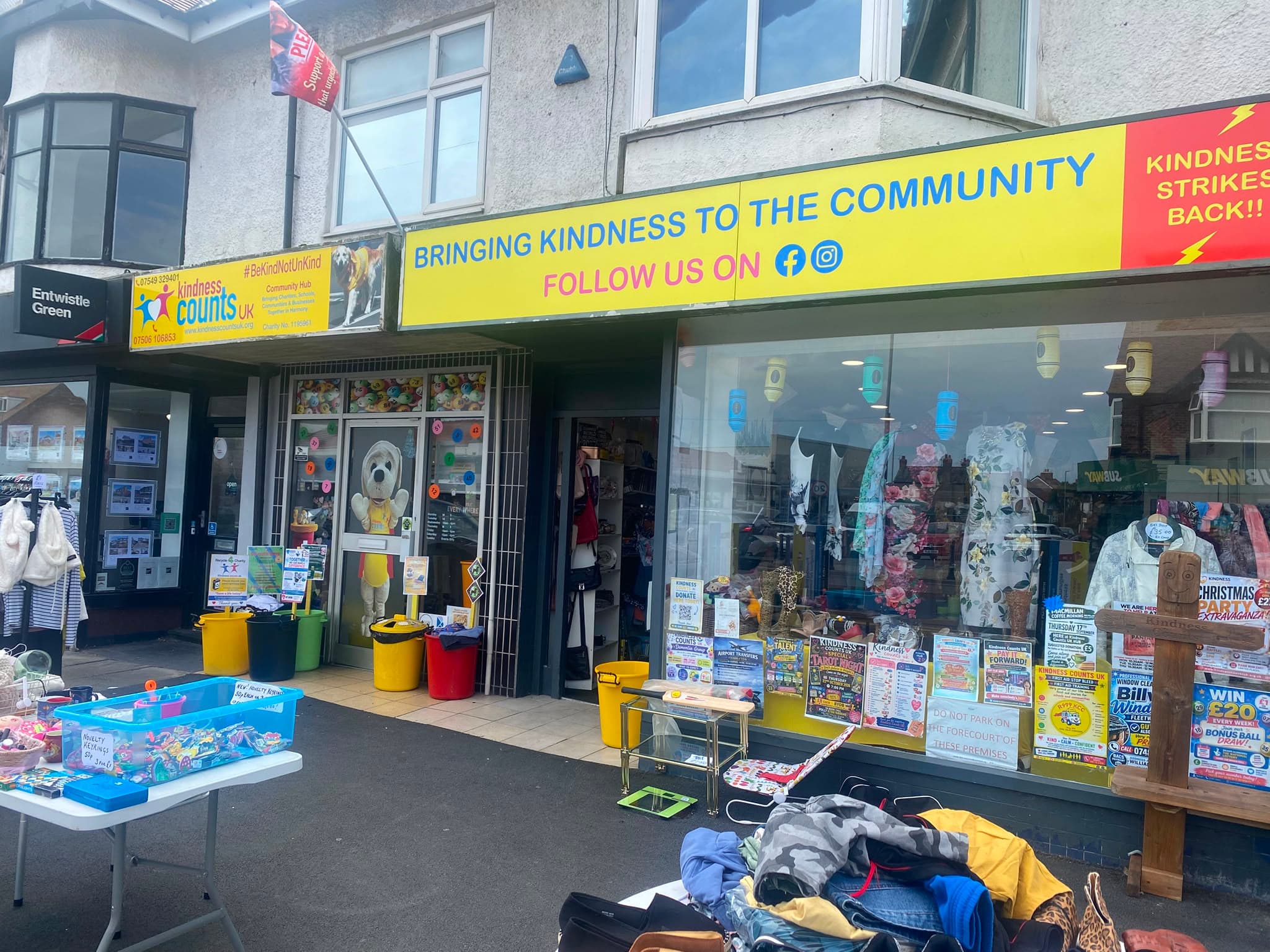 The charity shop front, with posters for the charity's events in the window.