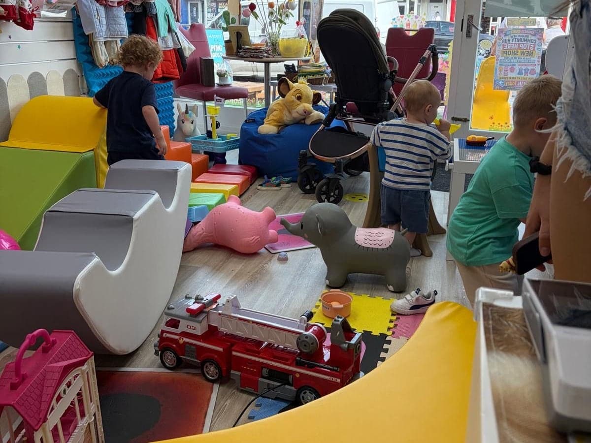 The soft play at Hub 3 in use, with children playing among the foam blocks and toys by the shop window.