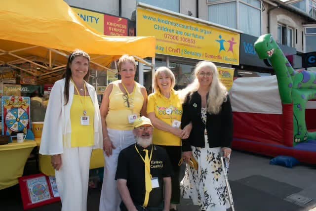 The Kindness Counts UK team in their yellow t-shirts at a community event outside Hub 3.
