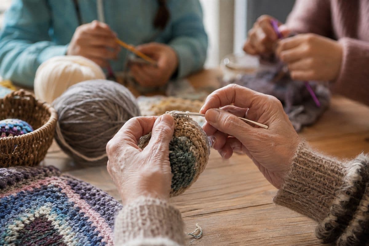 Close-up of hands working with soft blue yarn.