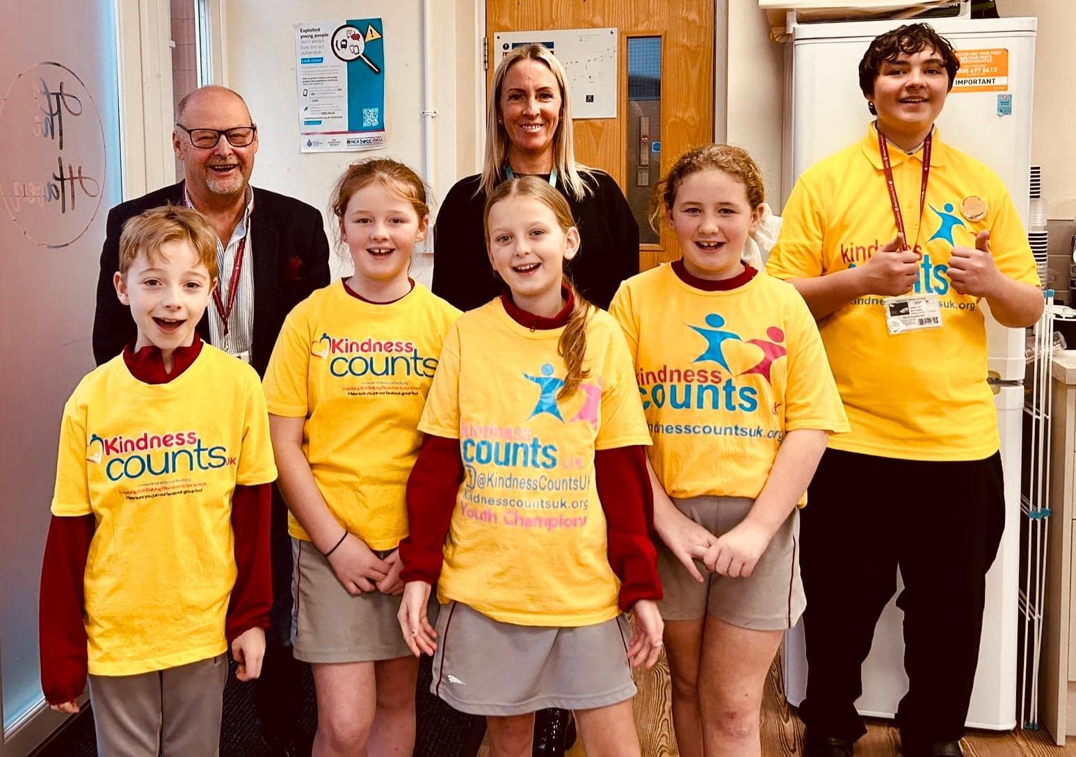 Youth champions in their yellow Kindness Counts UK t-shirts at their school.